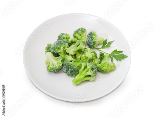 Frozen broccoli with parsley twig on a white dish