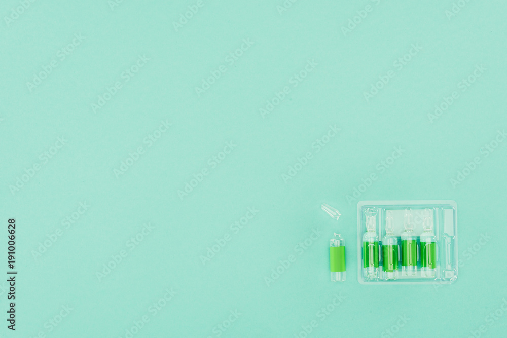 top view of arranged ampules isolated on green top view of arranged ampules isolated on green