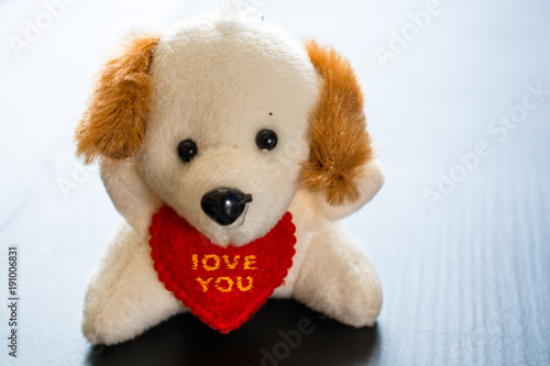 Soft plush toy dog with heart.