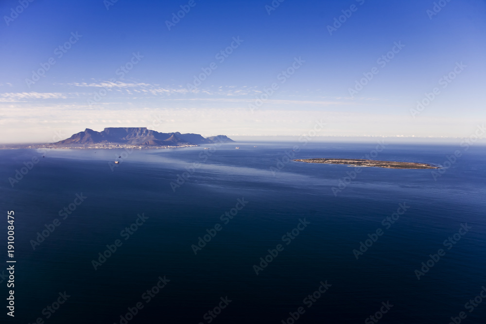Fototapeta premium Aerial view of Robben Island with Table Mountain in the distance, Cape Town; South Africa. Former South African President, Nelson Mandela, was held here as a political prisoner for 27 years.