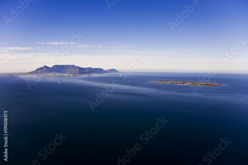 Aerial view of Robben Island with Table Mountain in the distance, Cape Town; South Africa. Former South African President, Nelson Mandela, was held here as a political prisoner for 27 years.