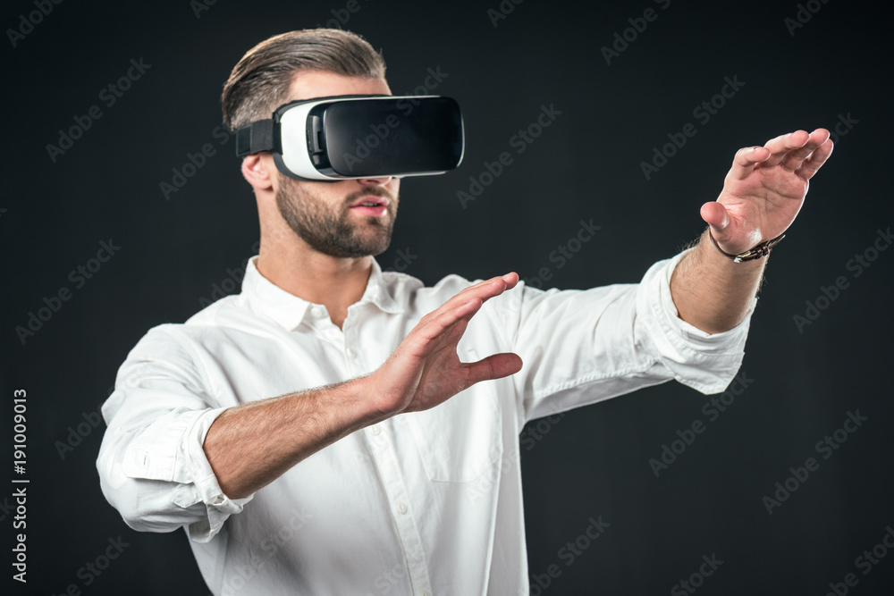 man gesturing and using virtual reality headset, isolated on black man gesturing and using virtual reality headset, isolated on black