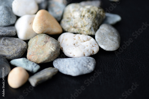 Scattered stones on a dark background close up