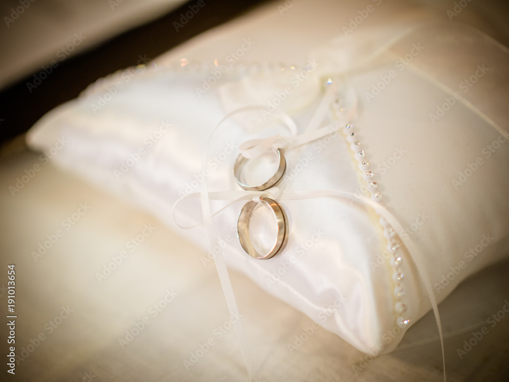 the wedding rings on the silk pillow are ready for wedding the wedding rings on the silk pillow are ready for wedding