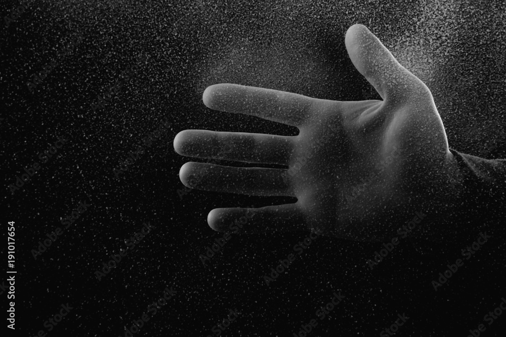Φωτογραφία cropped shot of person showing palm through frosted glass in darkness
