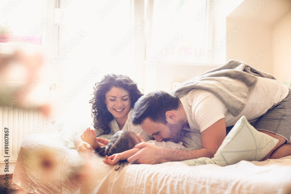 Little girl with her parents at morning.