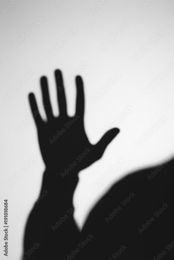 strange blurry shadow of human hand on grey