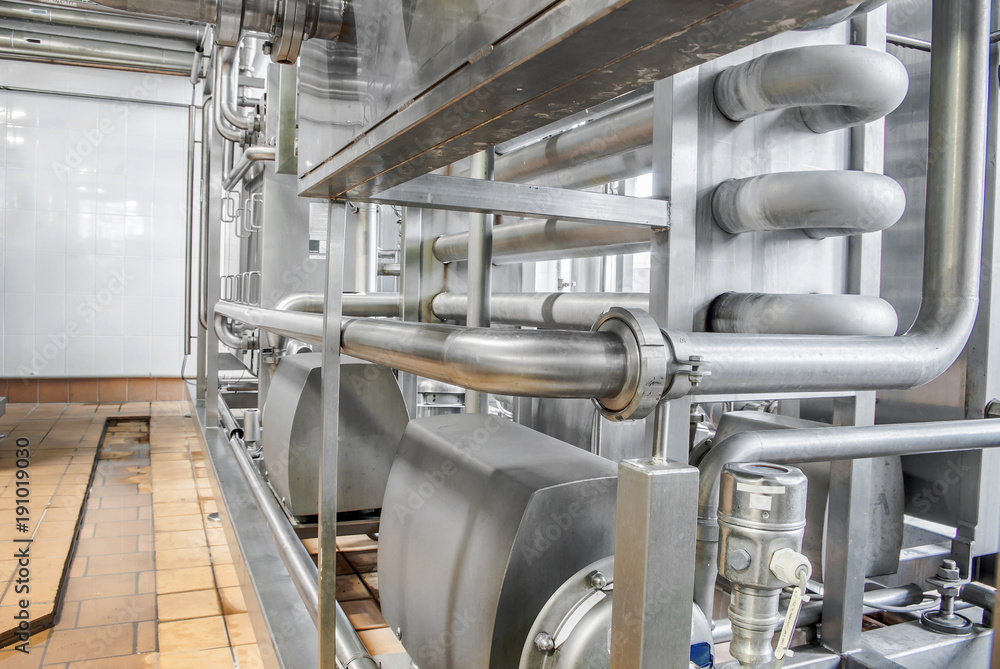 Stainless steel pipes in the factory. Construction on food production, Abstract industry background. Stainless steel pipes in the factory. Construction on food production, Abstract industry background.