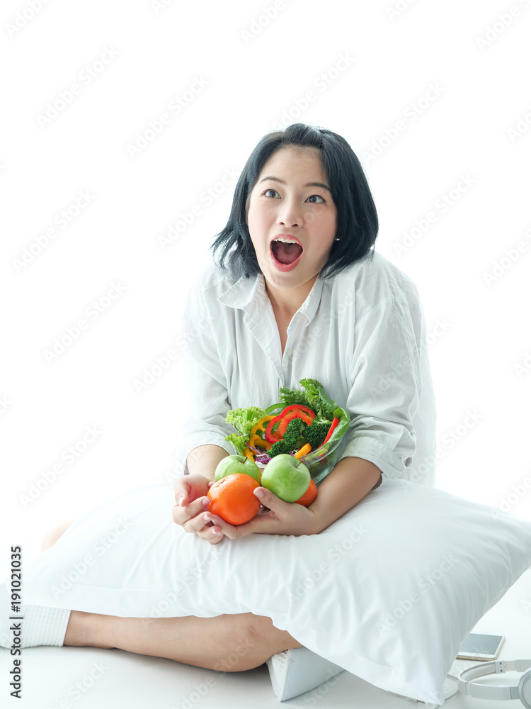 Young Asian woman with salad on white background Young Asian woman with salad on white background