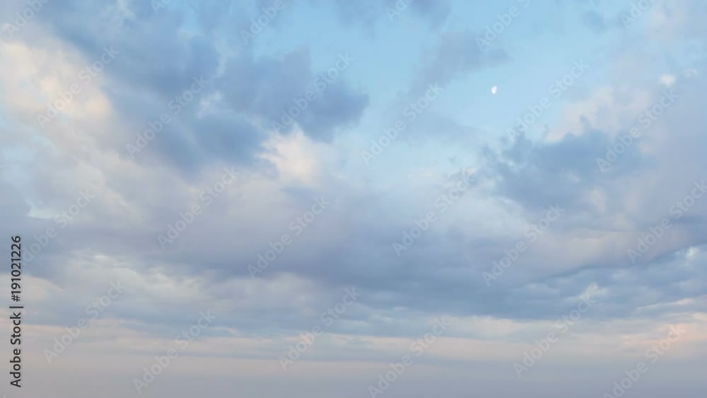 Russia, time lapse. Formation and rapid movement of white clouds of different shapes in the blue sky in late spring at sunset. Russia, time lapse. Formation and rapid movement of white clouds of different shapes in the blue sky in late spring at sunset.