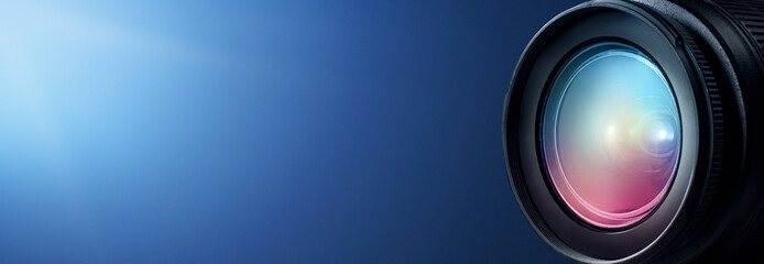 Camera lens close up and blue background