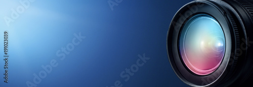 Camera lens close up and blue background photo