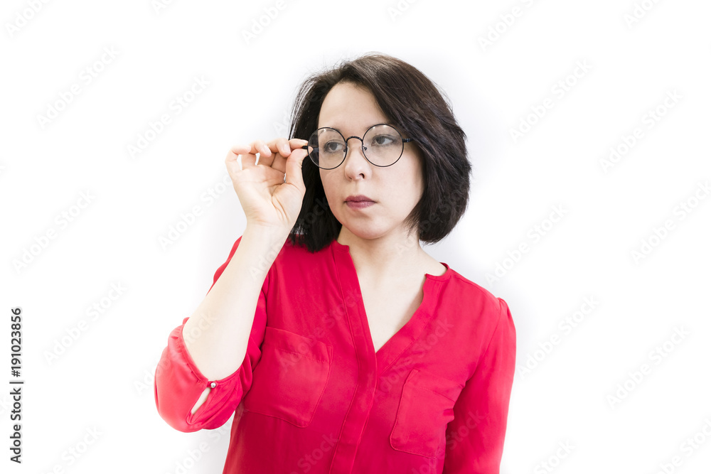 Young women look with suspicion through her glasses Young women look with suspicion through her glasses