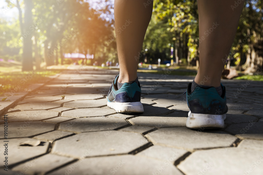 Young fitness man runner running on road in park. Running for lose weight and good health Young fitness man runner running on road in park. Running for lose weight and good health