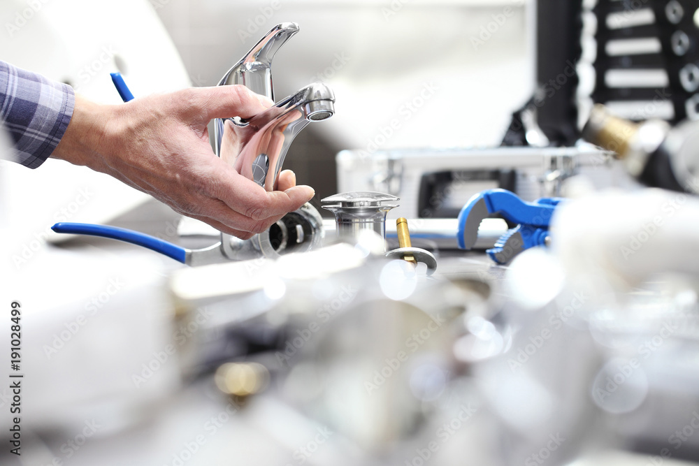 hands plumber at work in a bathroom, plumbing repair service, assemble and install concept hands plumber at work in a bathroom, plumbing repair service, assemble and install concept
