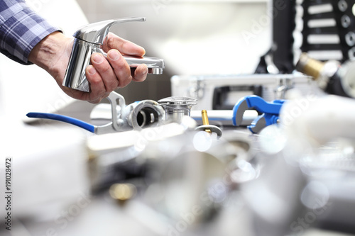 hands plumber at work in a bathroom, plumbing repair service, assemble and install concept