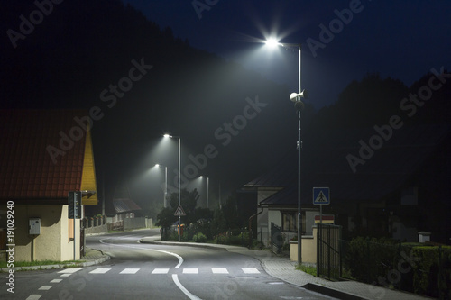 Fototapeta Naklejka Na Ścianę i Meble -  empty night street on small village with modern street lights