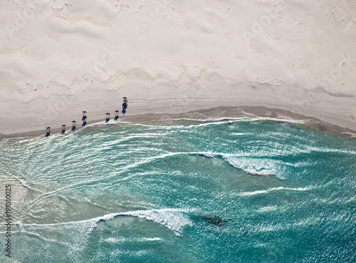 Aerial view of horses trotting on Noordhoek Beach in early morning. Riders are often spotted exercising their horses on this beautiful Cape Town beach. photo