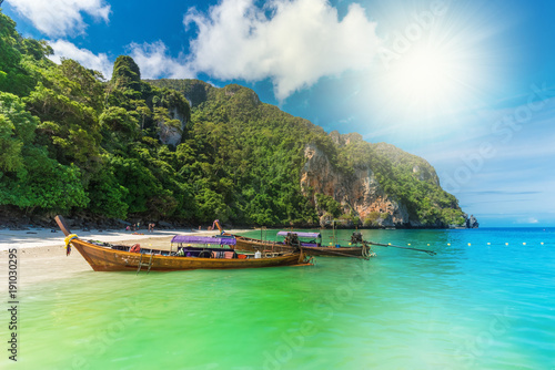 Beautiful travel scene with traditional boat on Monky beach on the coast of Phi Phi region in Thailand island