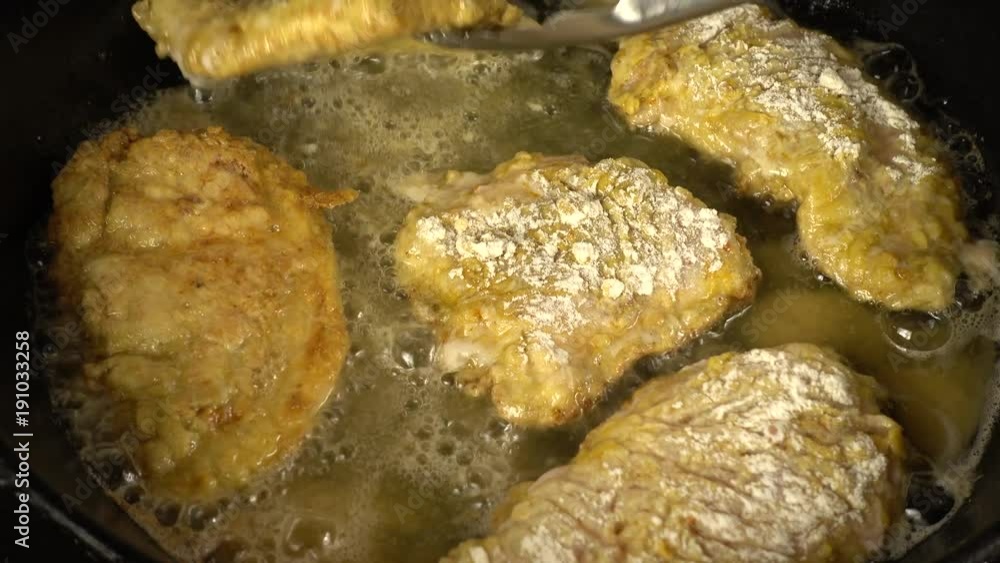 Preparation of a chicken chop on a cast-iron pan. Preparation of a chicken chop on a cast-iron pan.