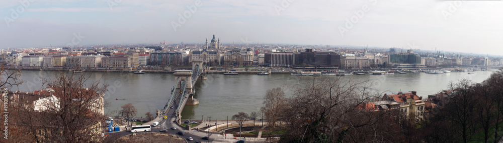 Fototapeta premium large wide panorama of the city of budapest with historic buildings chain bridge and city skyline with boats along the river danube