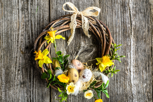 Easter background with spring wreath hanging on door photo