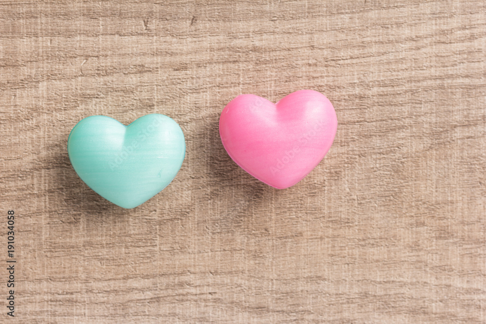 Couple of blue and red heart shapes over wooden table. Valentine day. Background use. Concept of love and romance.