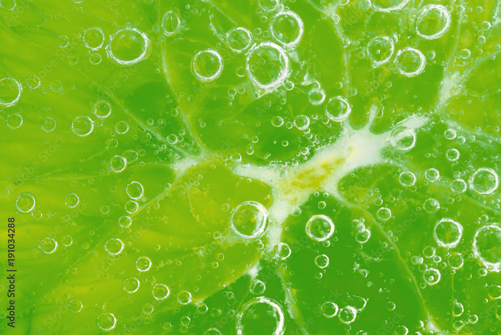 Lime orange. Lime orange slice in water with bubbles. Close-up. Citrus texture