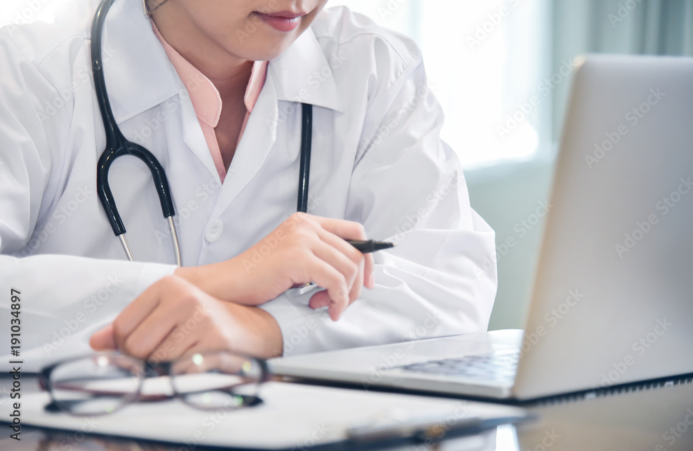 Asian Female Doctor working with laptop. Asian Female Doctor working with laptop.