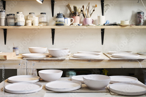 Ceramic studio equipment for craft work with clay, color, glaze. Daylight in art loft space