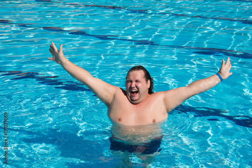 Vacation. Funny fat guy and pool. 