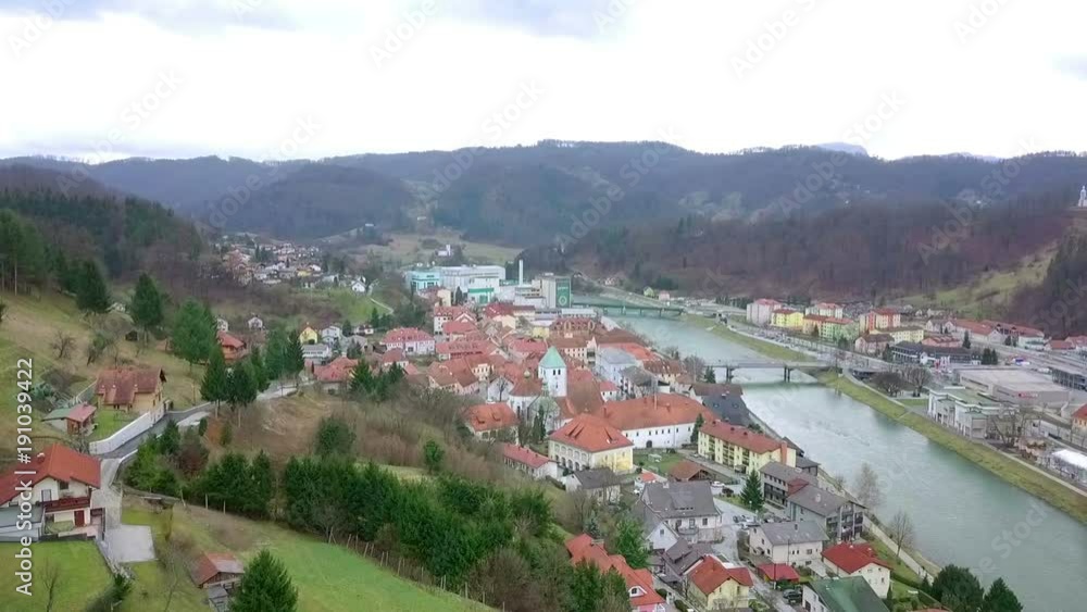 Aerial: Flying in front of city Lasko in Slovenia. Drone going down in slow motion. Aerial: Flying in front of city Lasko in Slovenia. Drone going down in slow motion.
