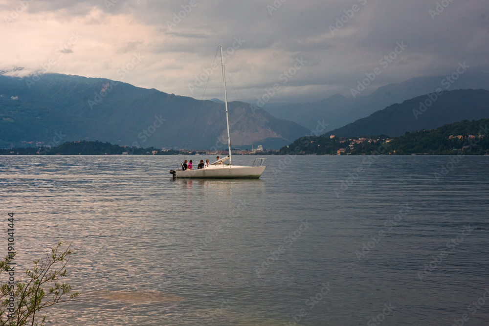 Some people on a sailboat in the lake Some people on a sailboat in the lake