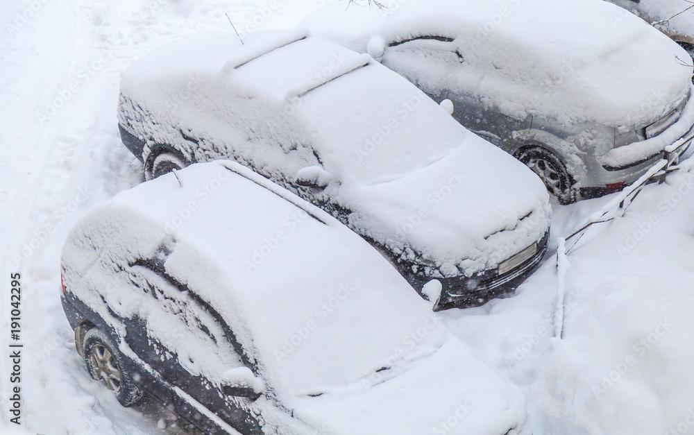 top view parked cars snowed during a snowfall