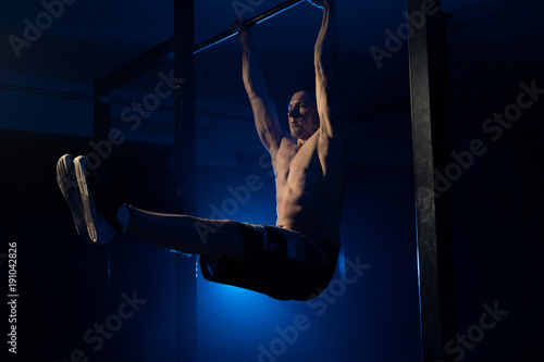 The man does pull-ups on the crossbar. Health. sport © semenenkostas