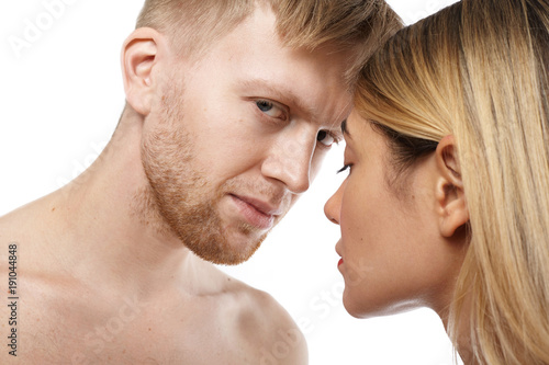 Bilde på lerret Close up isolated view of attractive shirtless unshaven Caucasian guy going to make love to beautiful tender blonde woman
