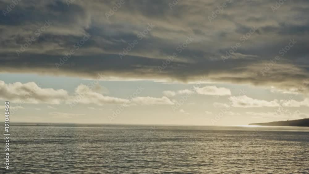 Marvellous vanilly sky over an island and beautiful reflection in the ocean.