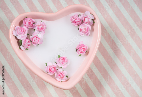 Decoration for Valentine s Day  pink heart shaped candle with little artificial flowers
