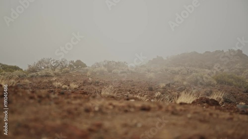Menacing fog on rocky ground.
