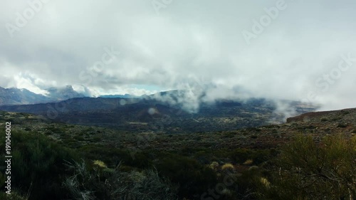 Time lapse of dramatic clouds over mountains.