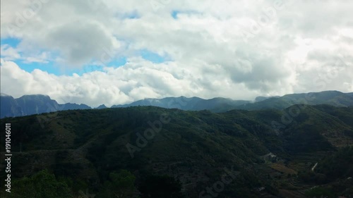 Time lapse of dramatic clouds over mountains.