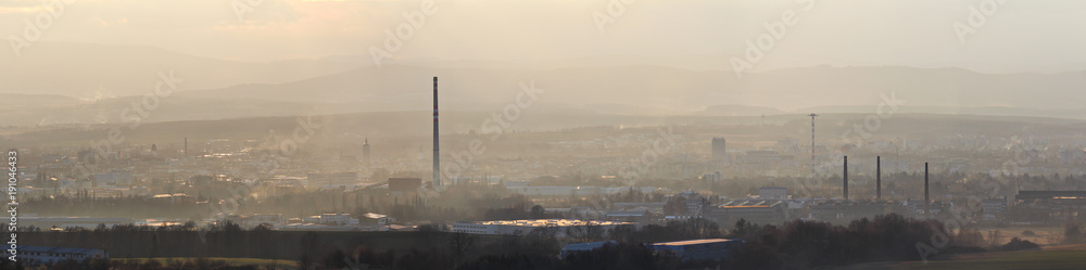 Panoramtic city Ceske Budejovice in winter sunset and strong fog
