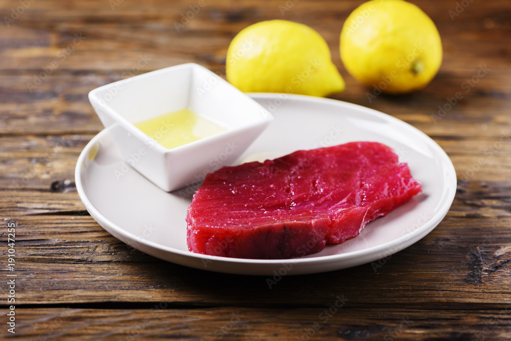 Raw fresh tuna fish on the wooden table Raw fresh tuna fish on the wooden table