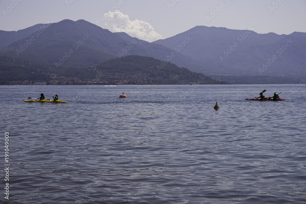 Some canoes line the quiet waters of Lake Maggiore in Italy