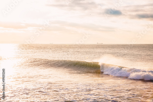 Perfect ocean wave. Landscape with sunrise or sunset colors