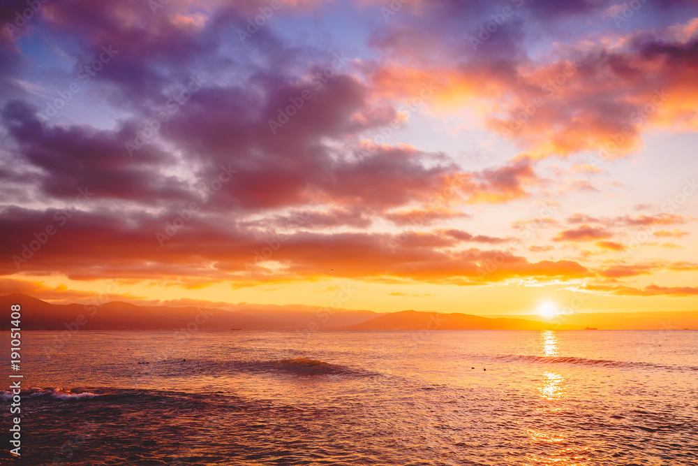Bright sunset or sunrise in ocean. Landscape with warm sunset or sunrise colors Bright sunset or sunrise in ocean. Landscape with warm sunset or sunrise colors