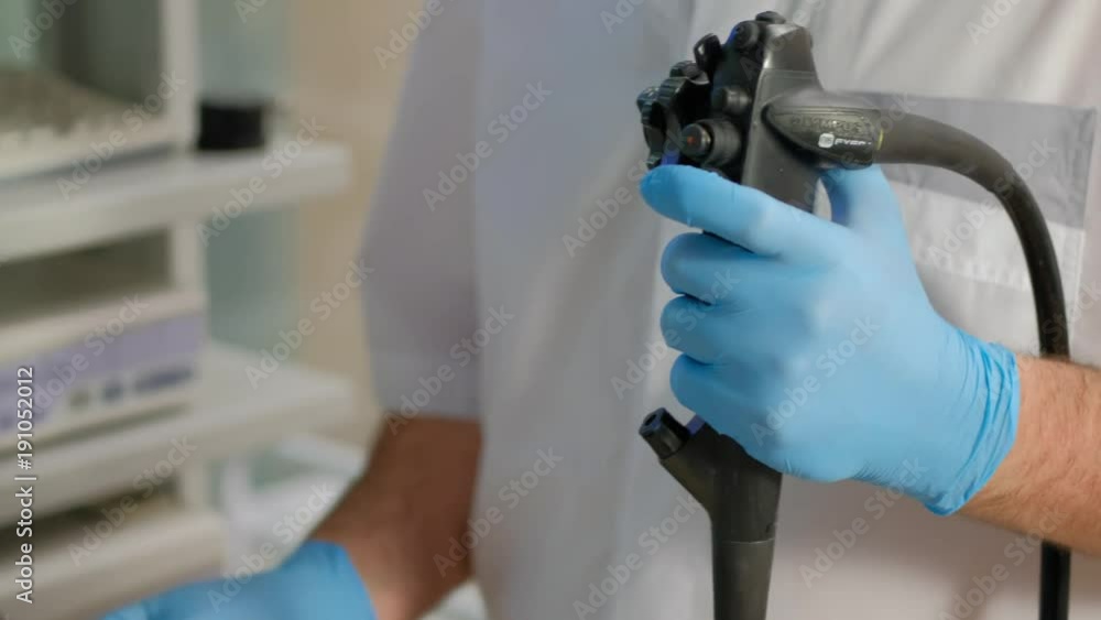 Doctor gastroenterologist with probe to perform gastroscopy and colonoscopy Doctor gastroenterologist with probe to perform gastroscopy and colonoscopy