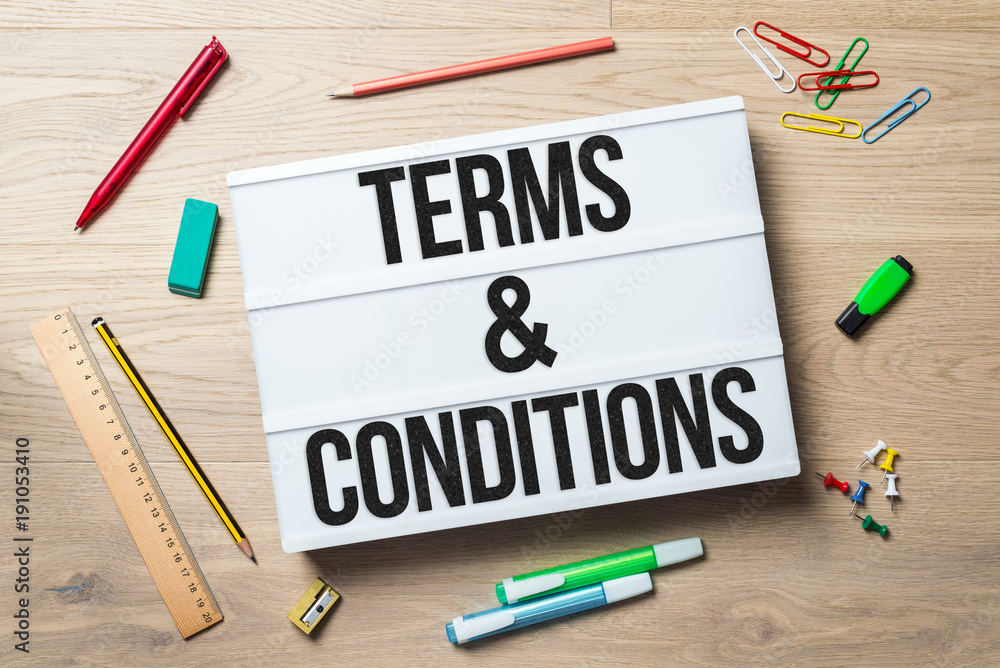 Terms and conditions written on lightbox in office as flatlay Terms and conditions written on lightbox in office as flatlay