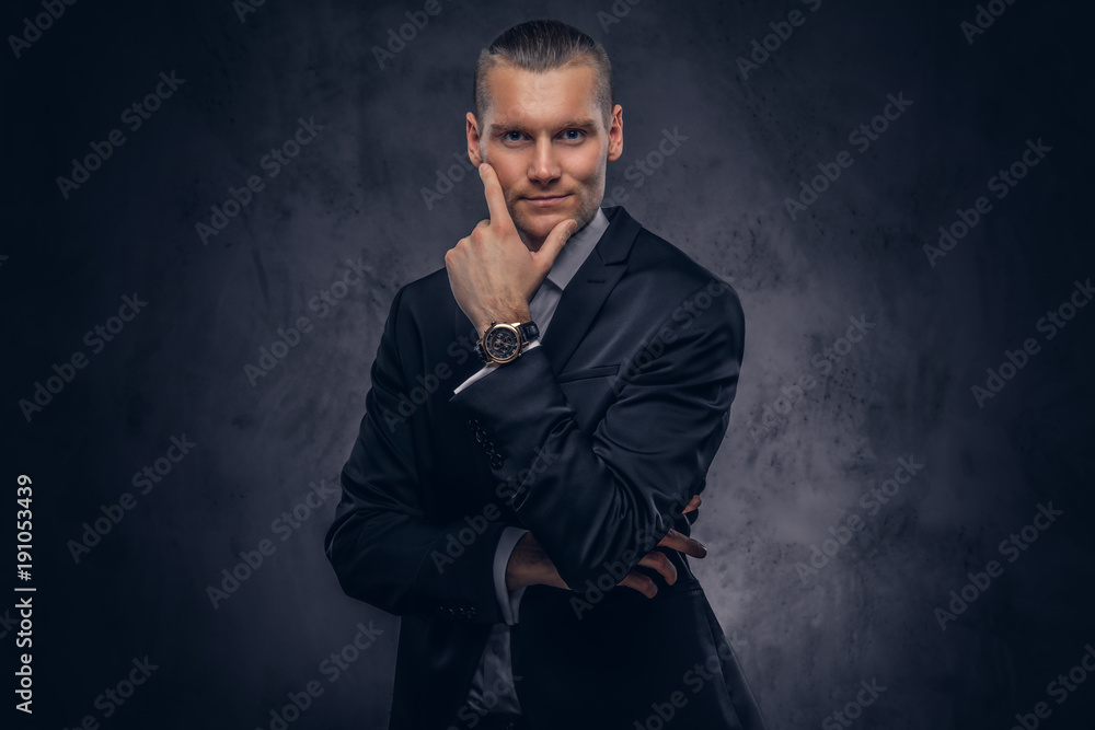 Handsome businessman against a dark background.