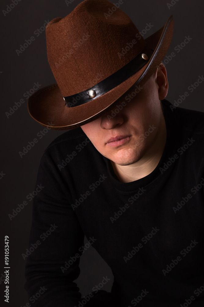 Mr. X. The secretive man in a cowboy hat covering his eyes Stock